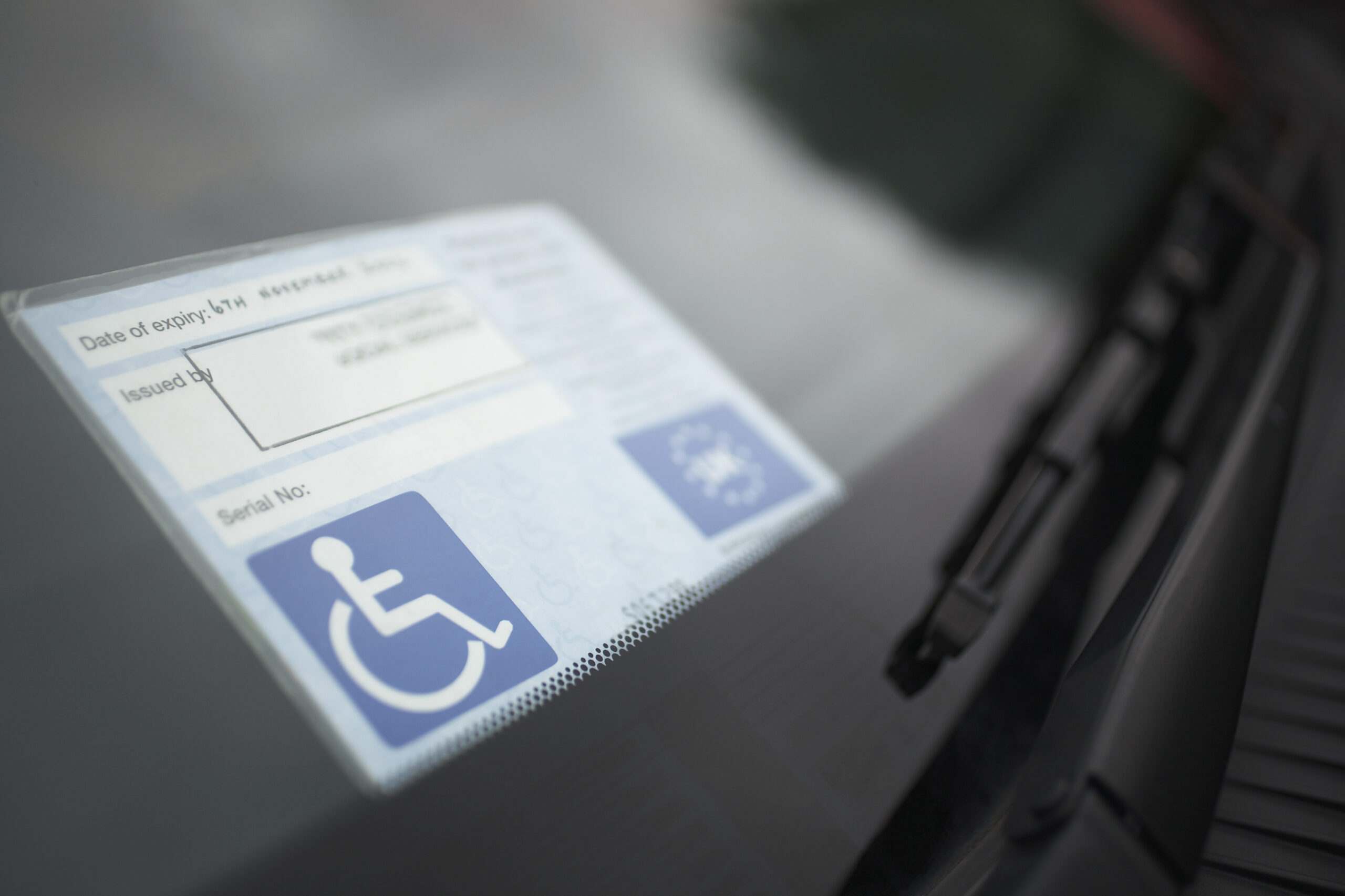 Disability placard in the window of a car for tips for travelling with a disability