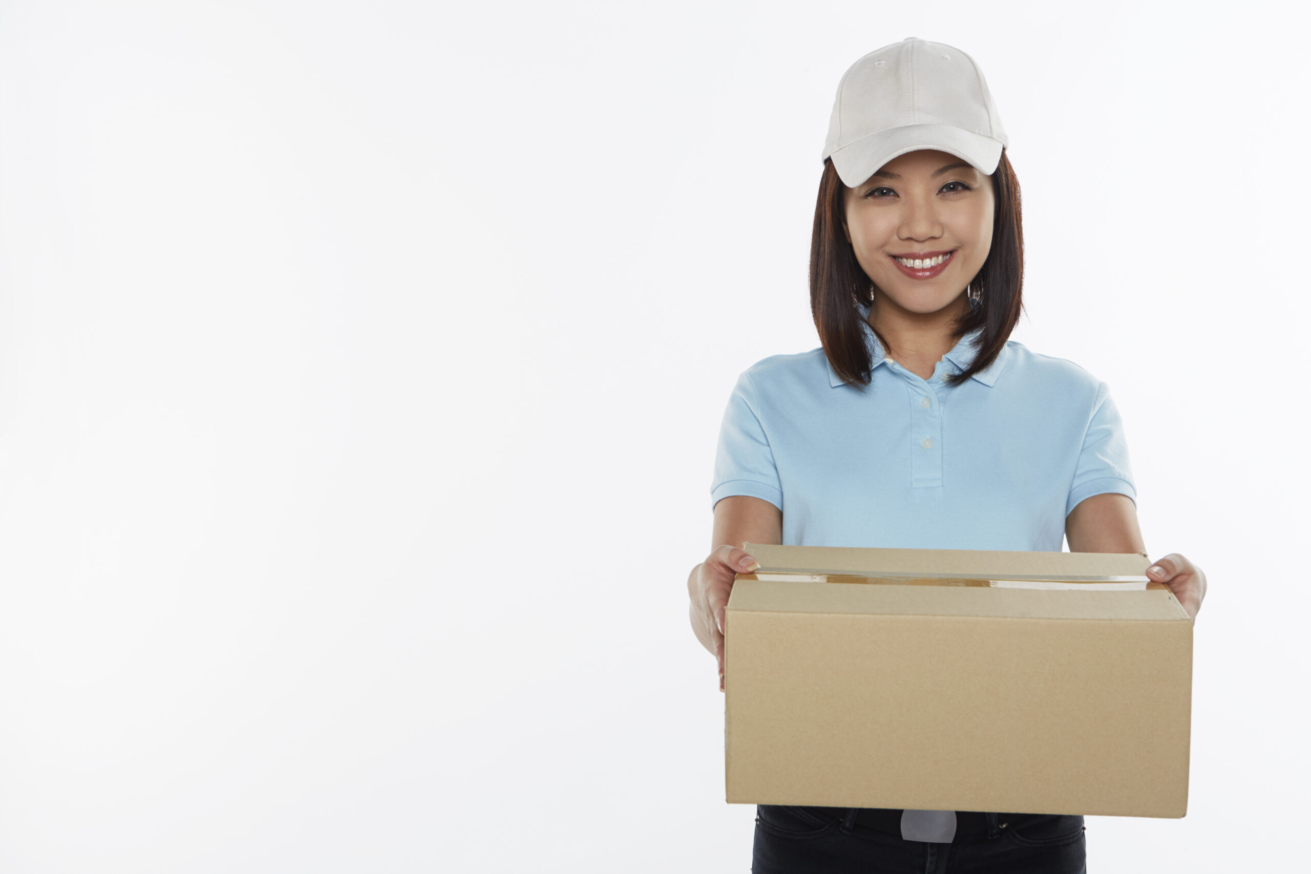 Delivery person carrying a cardboard box with deliveries following Christmas
