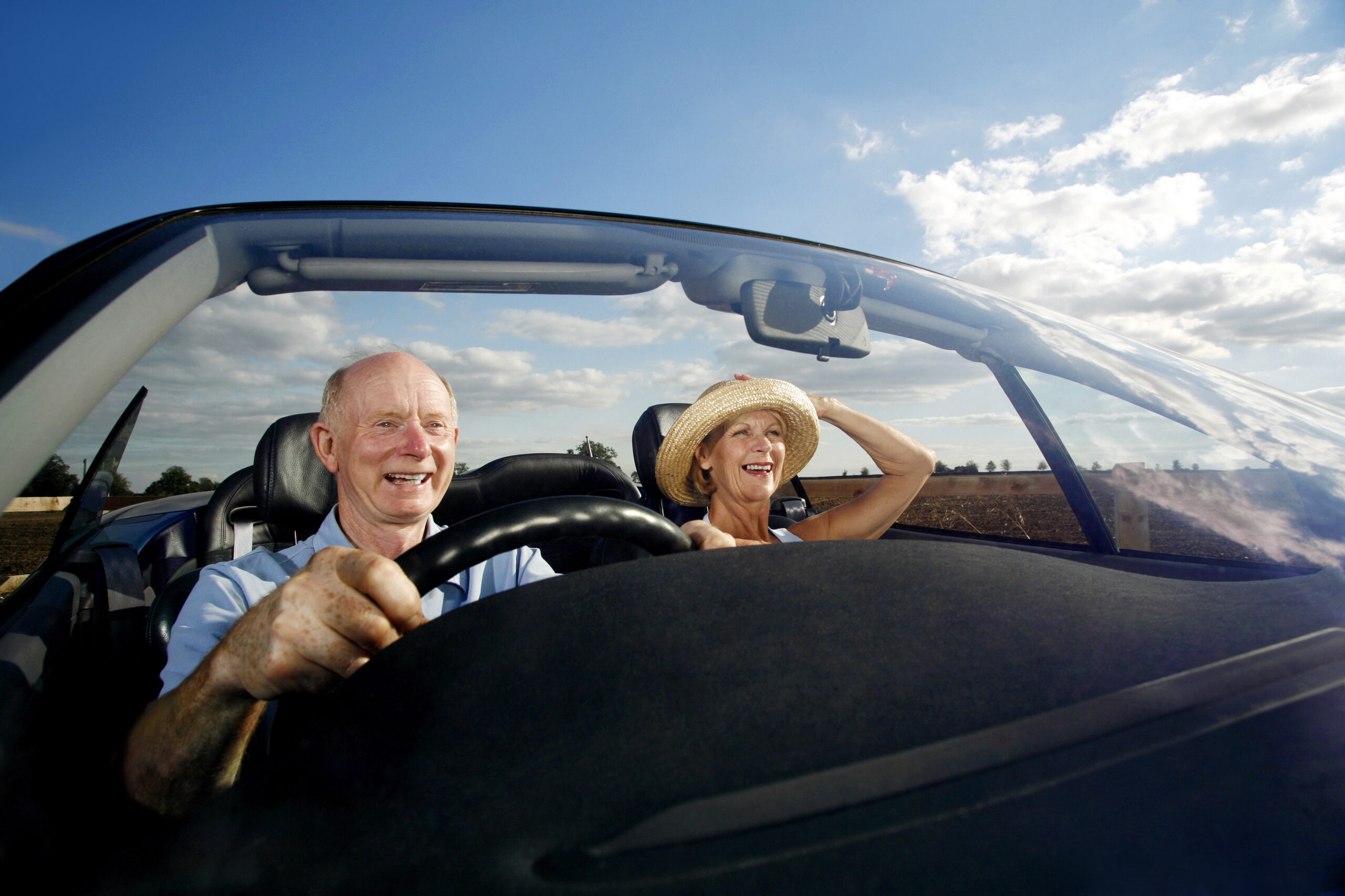 Older couple driving in a Citroen