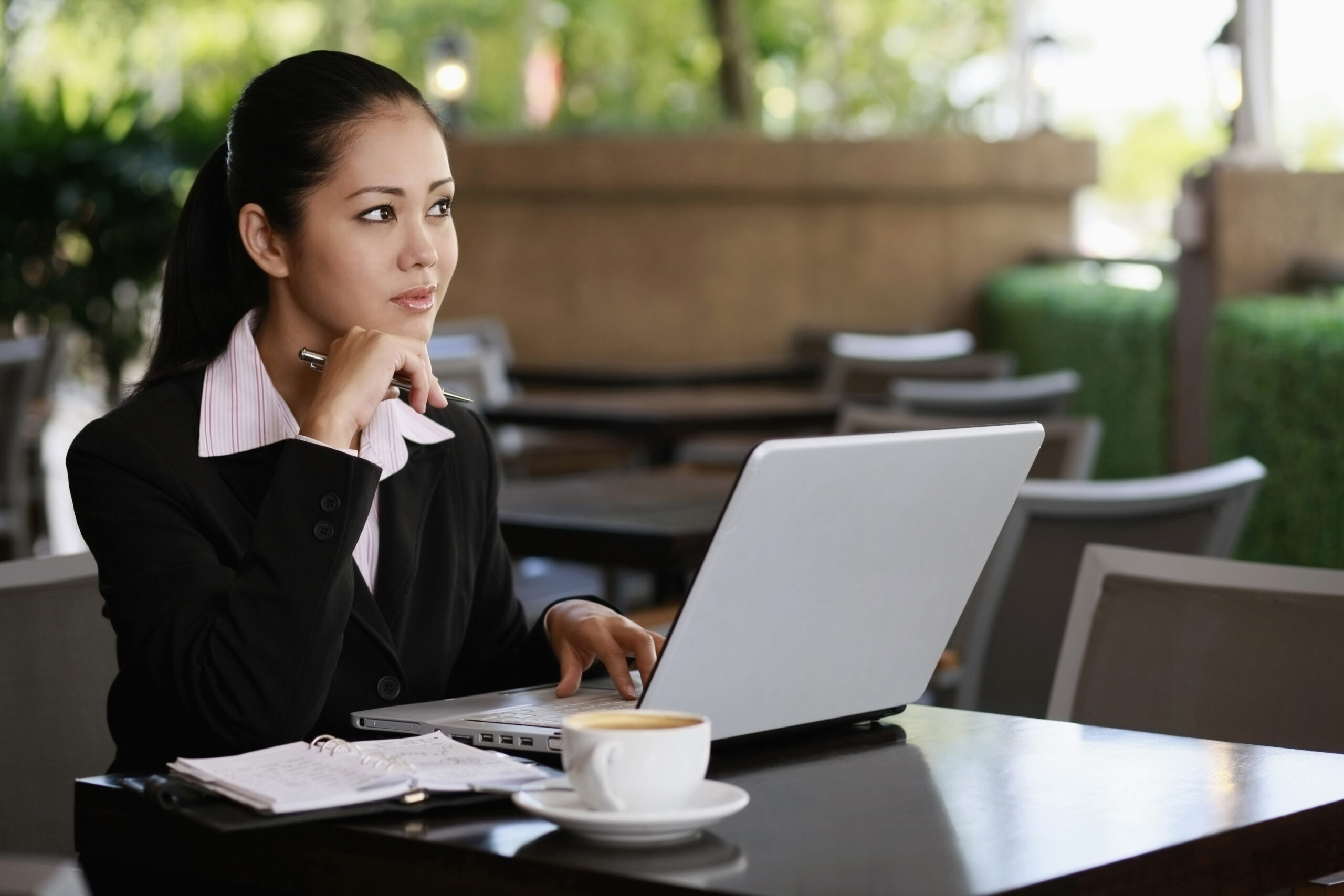 Woman sat at a desk with her new laptop