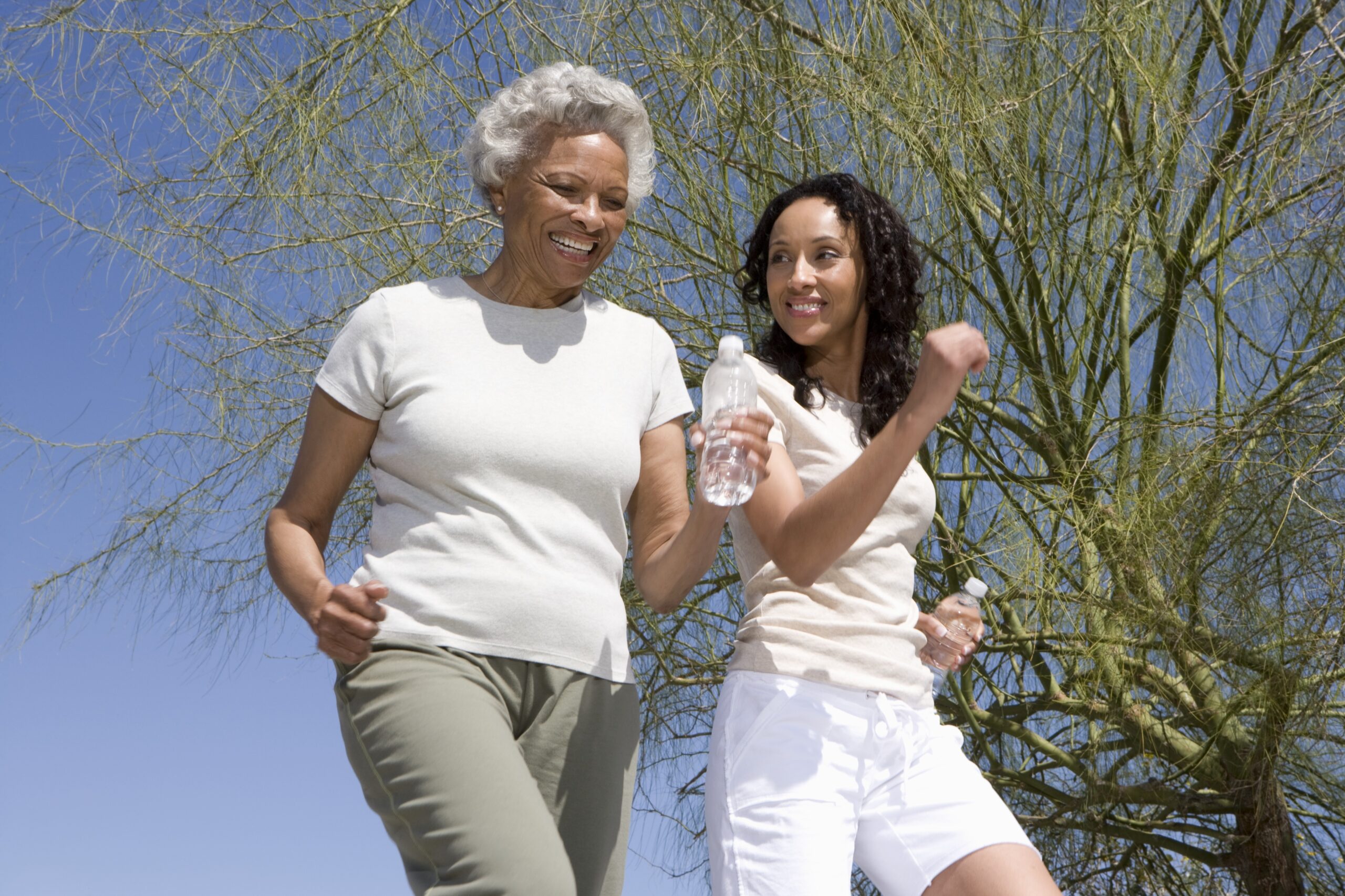 Elder woman and daughter taking a jog outside
