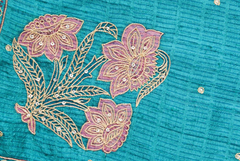 Peacock blue silk cloth with pink and gold flowers embroidered