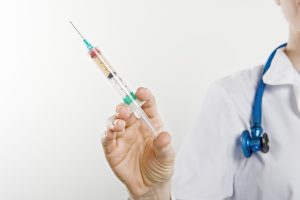 Nurse holding a syringe