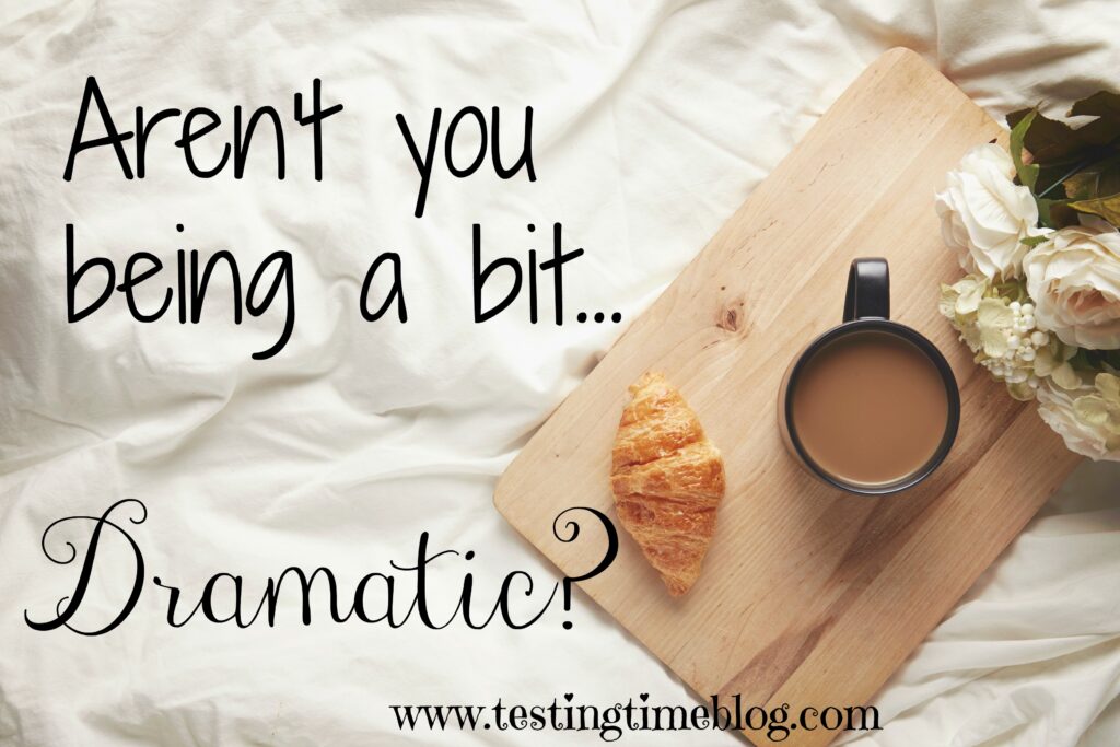 Aren't you being a bit dramatic? Flay lay on a bed with coffee, flowers and a croissant on a wooden board sat on the bed.