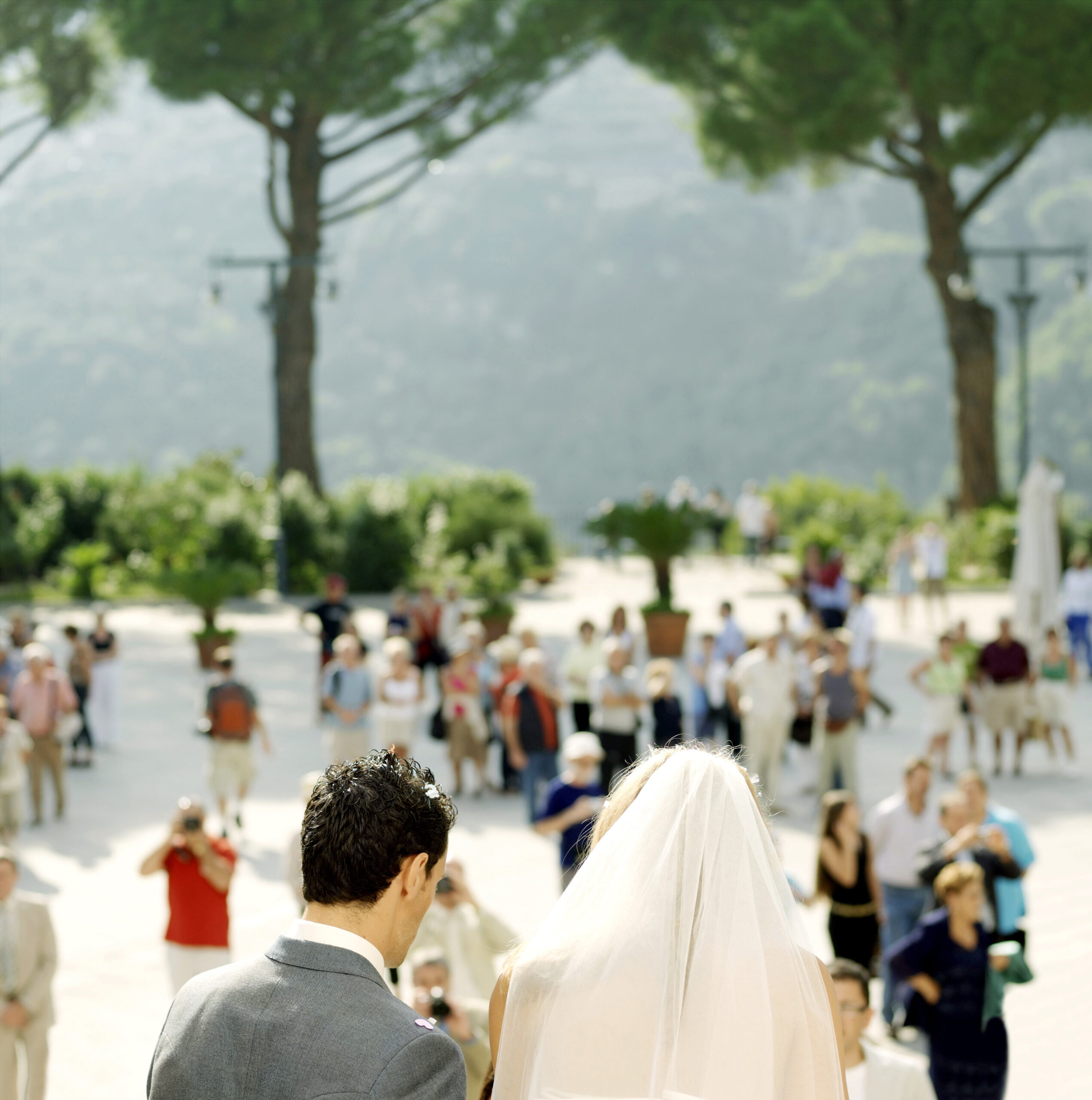 many people in the background taking wedding photos