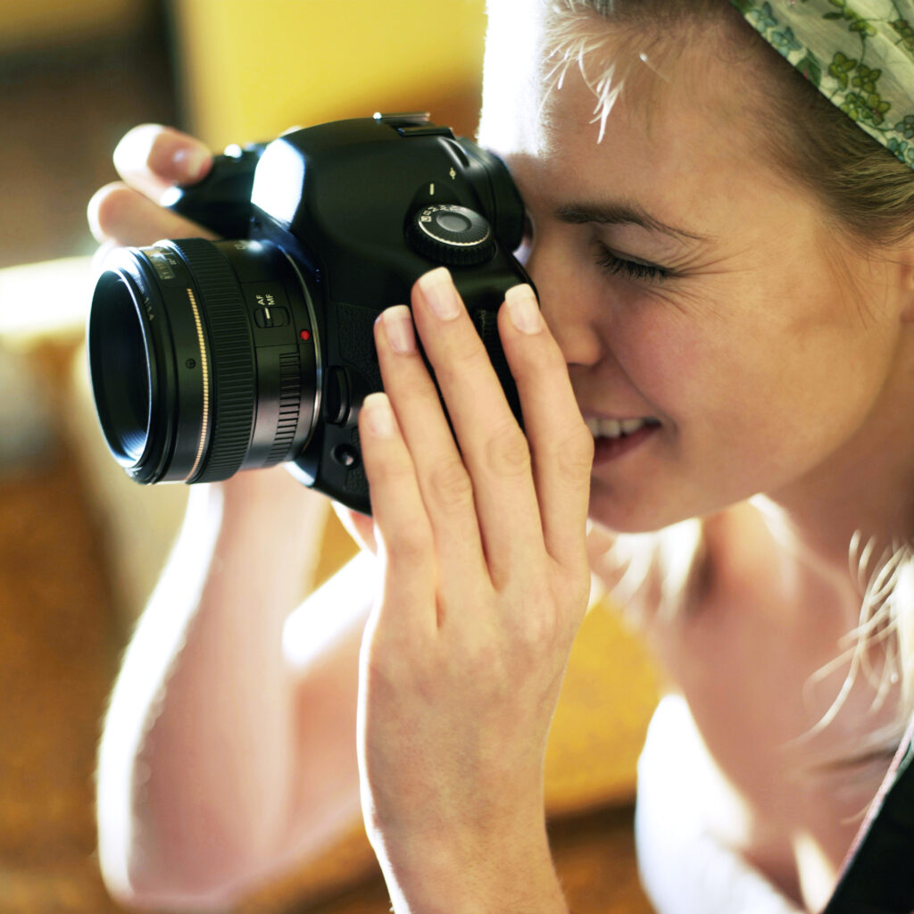 Professional female photographer taking picture