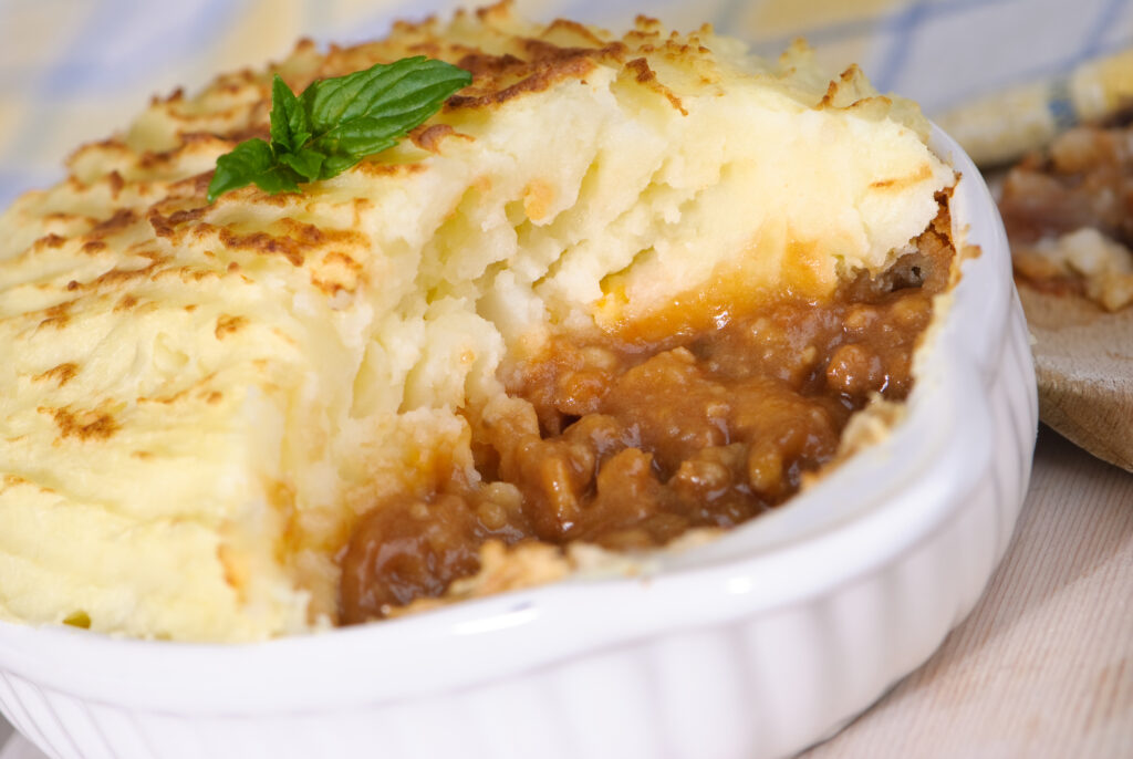 Close up of a shepherds pie with portion removed