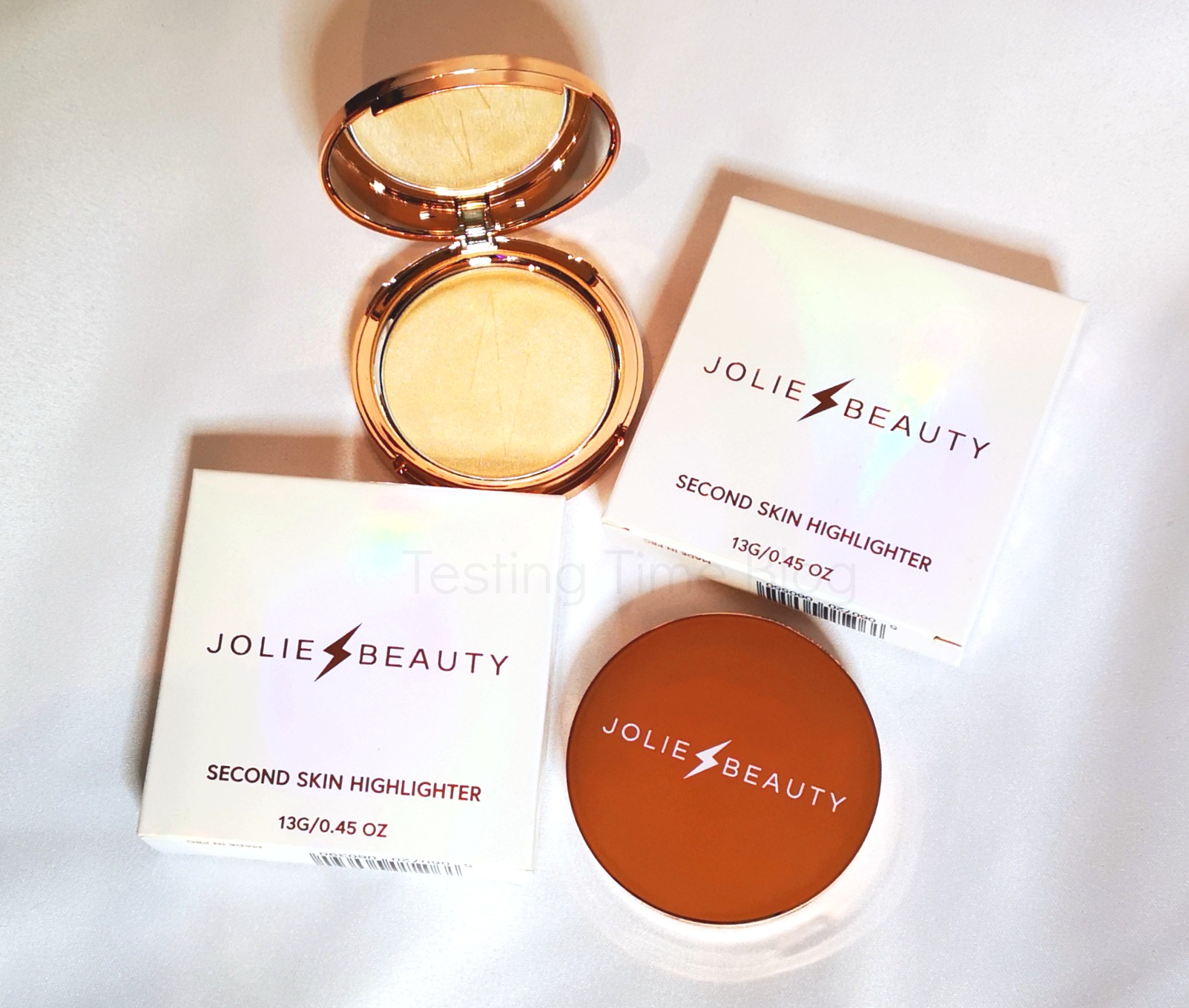 Jolie Beauty Second Skin Highlighter packaging showing the white box and rose gold compact