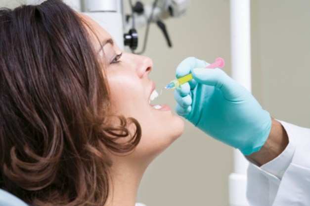 Dentist inspecting patient's teeth and health tourism